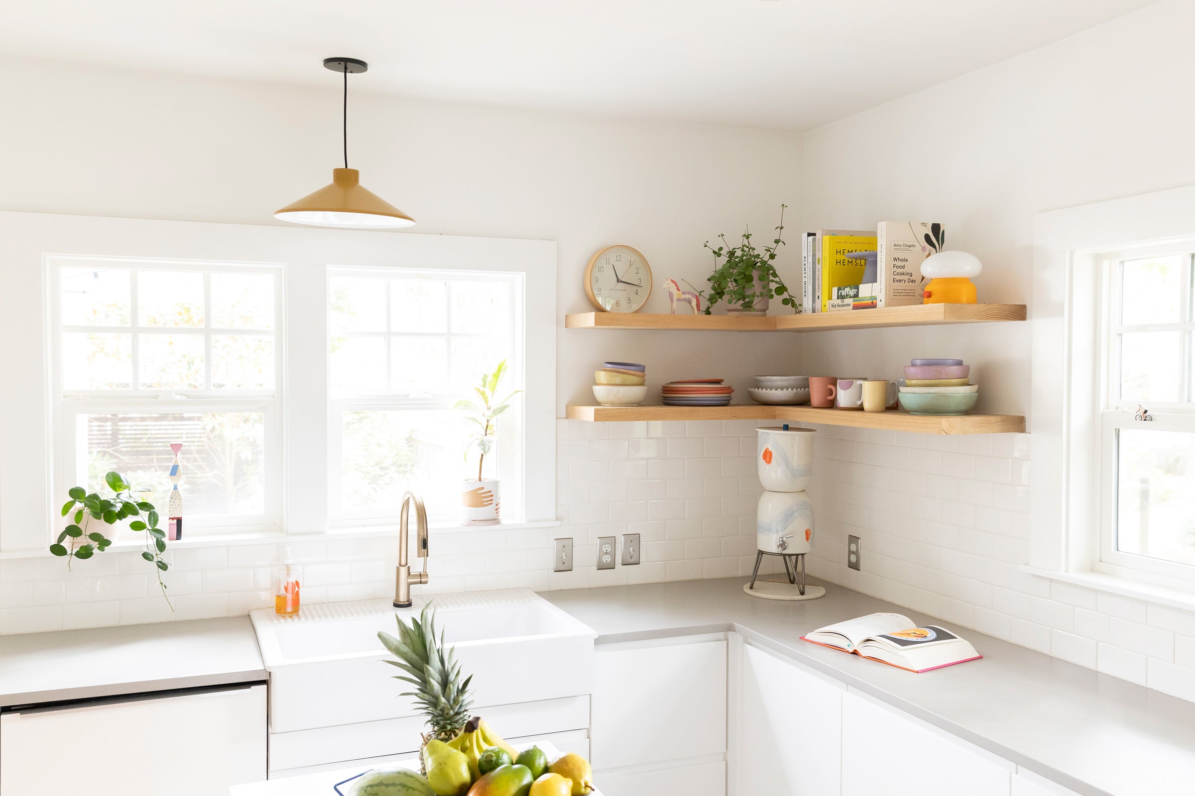 A bright kitchen with a pendant light over the sink.