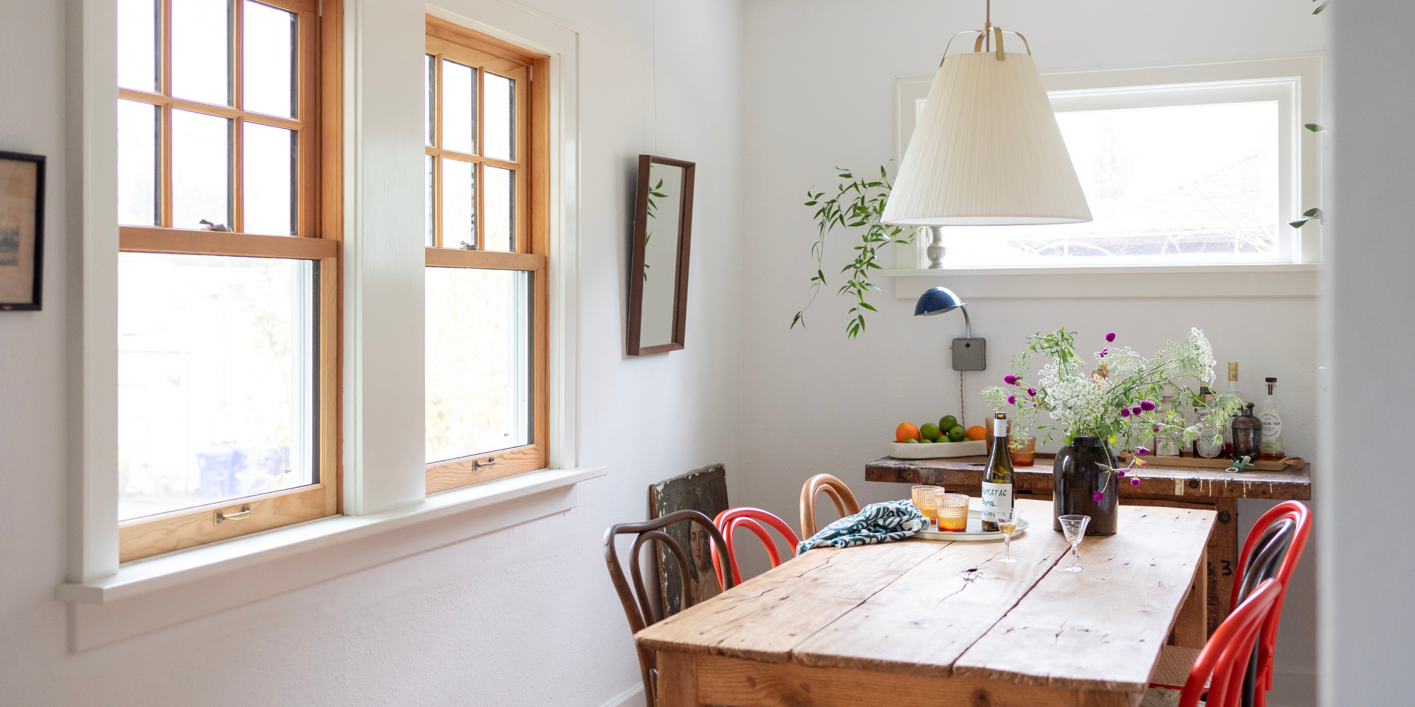 Farm style table with miss matched chairs in small dining room